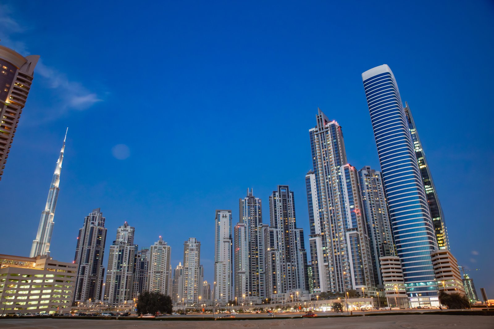 dubai city skyline with burj khalifa illuminated at blue hour in downtown dubai, united arab emirates